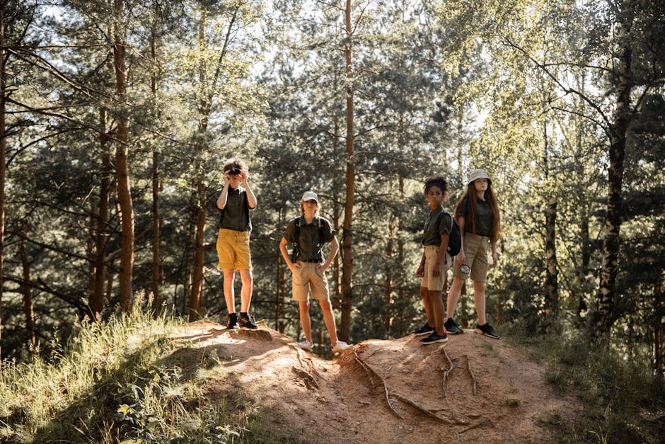 Group of children hiking in a sunlit forest, enjoying nature and exploration